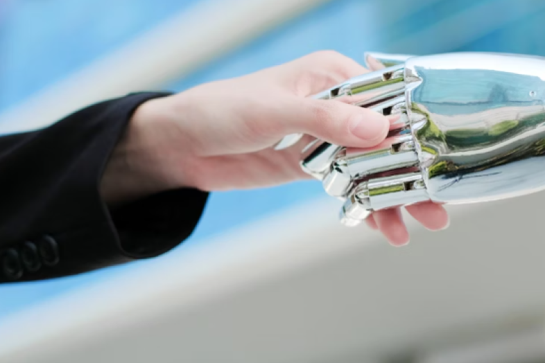 human hand shakes robot's hand