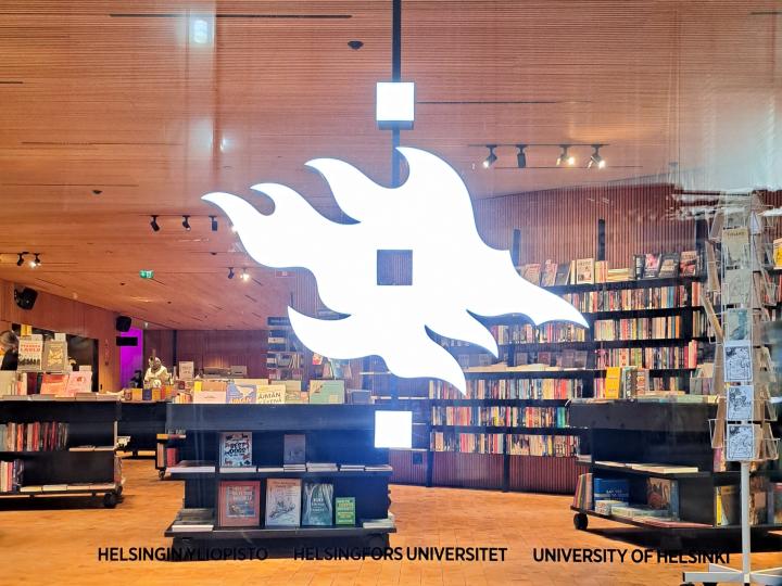 Yliopiston liekkimerkki Tiedekulman ikkunassa.