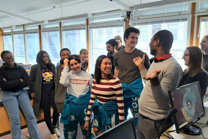 A group of students chatting in a lecture hall.